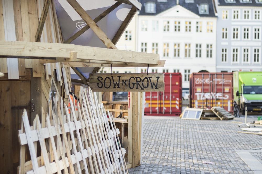 Sow N' Grow signage hanged on wooden log