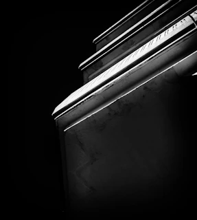 An artistic black and white photo highlighting textures and contrasts in an architectural detail
