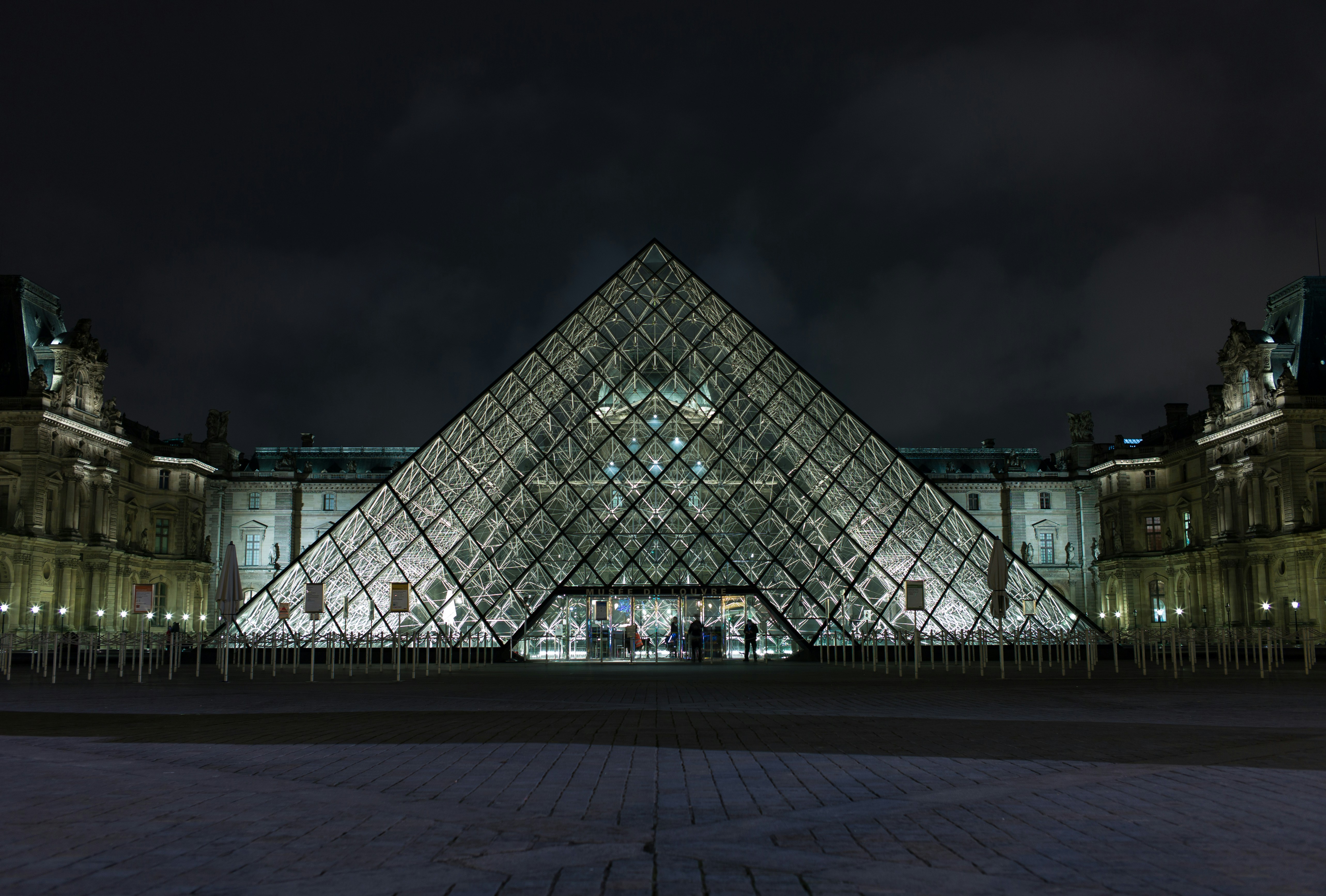 pyramid-shaped clear glass building during night