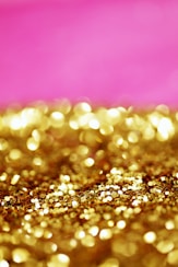 a pink and gold background with lots of gold glitter