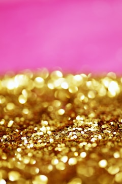 a pink and gold background with lots of gold glitter