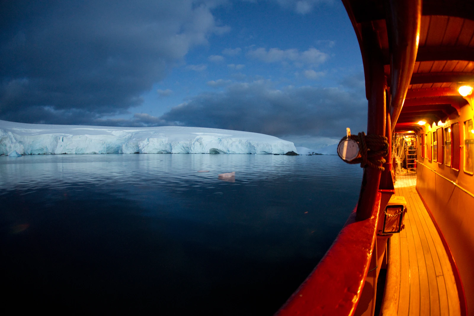 Vessel sailing toward icebergs in Antarctic waters