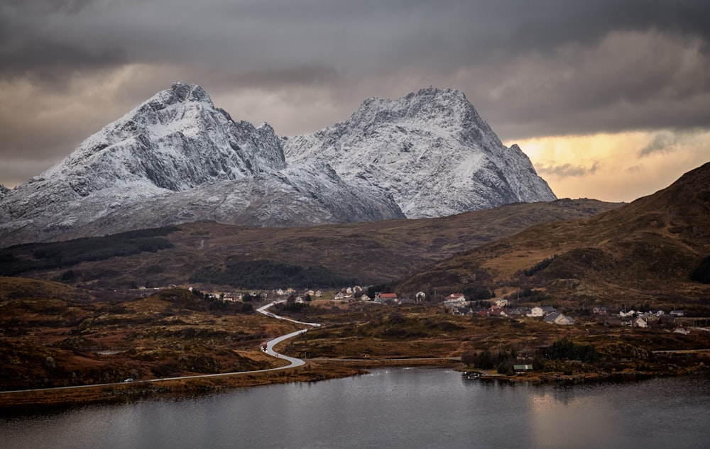 mountain beside forest and villagers