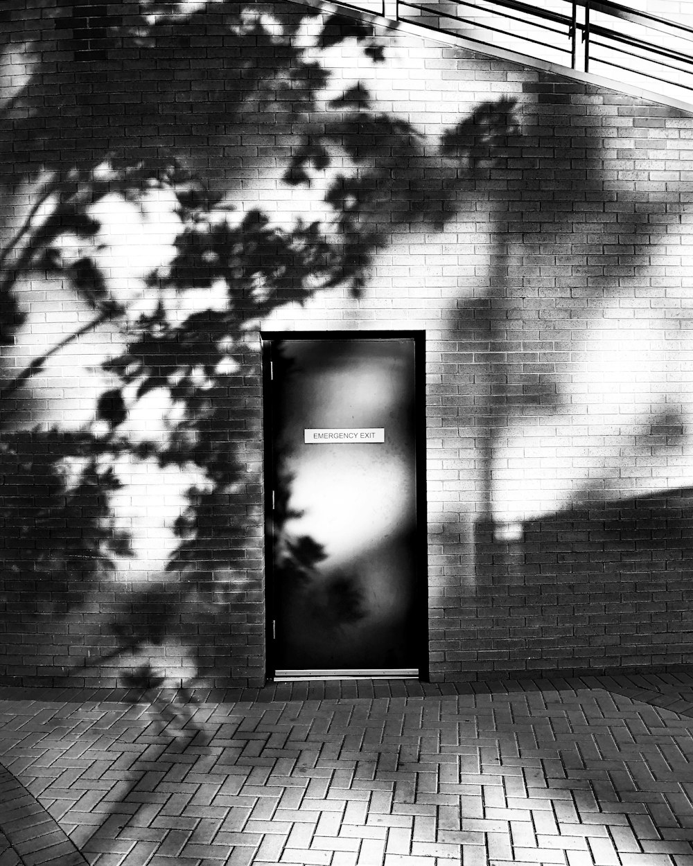 grayscale photo of Emergency Exit door