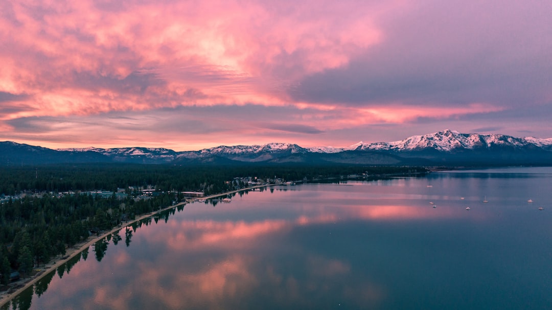 panoramic photography of body of water near mountain, Flying over Lake Tahoe at sunrise.