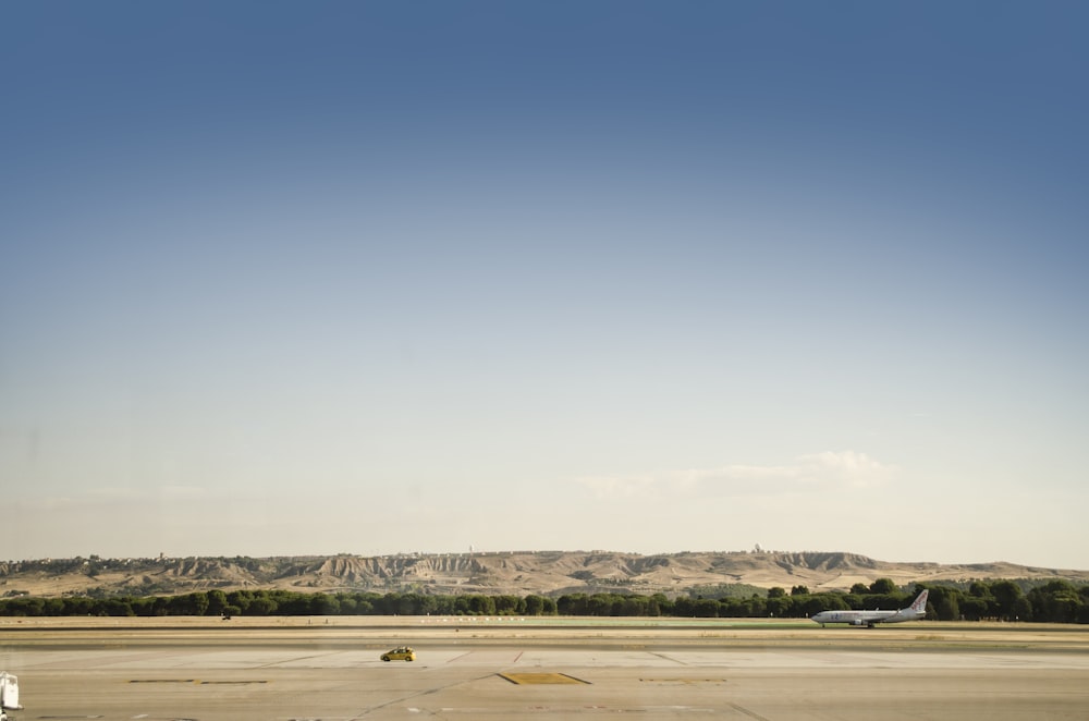 plane on runway with mountain in background