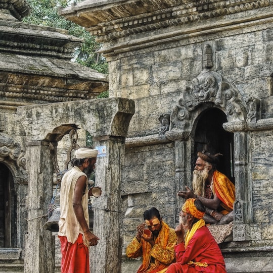 four men on ruins in Pashupatinath Temple Nepal