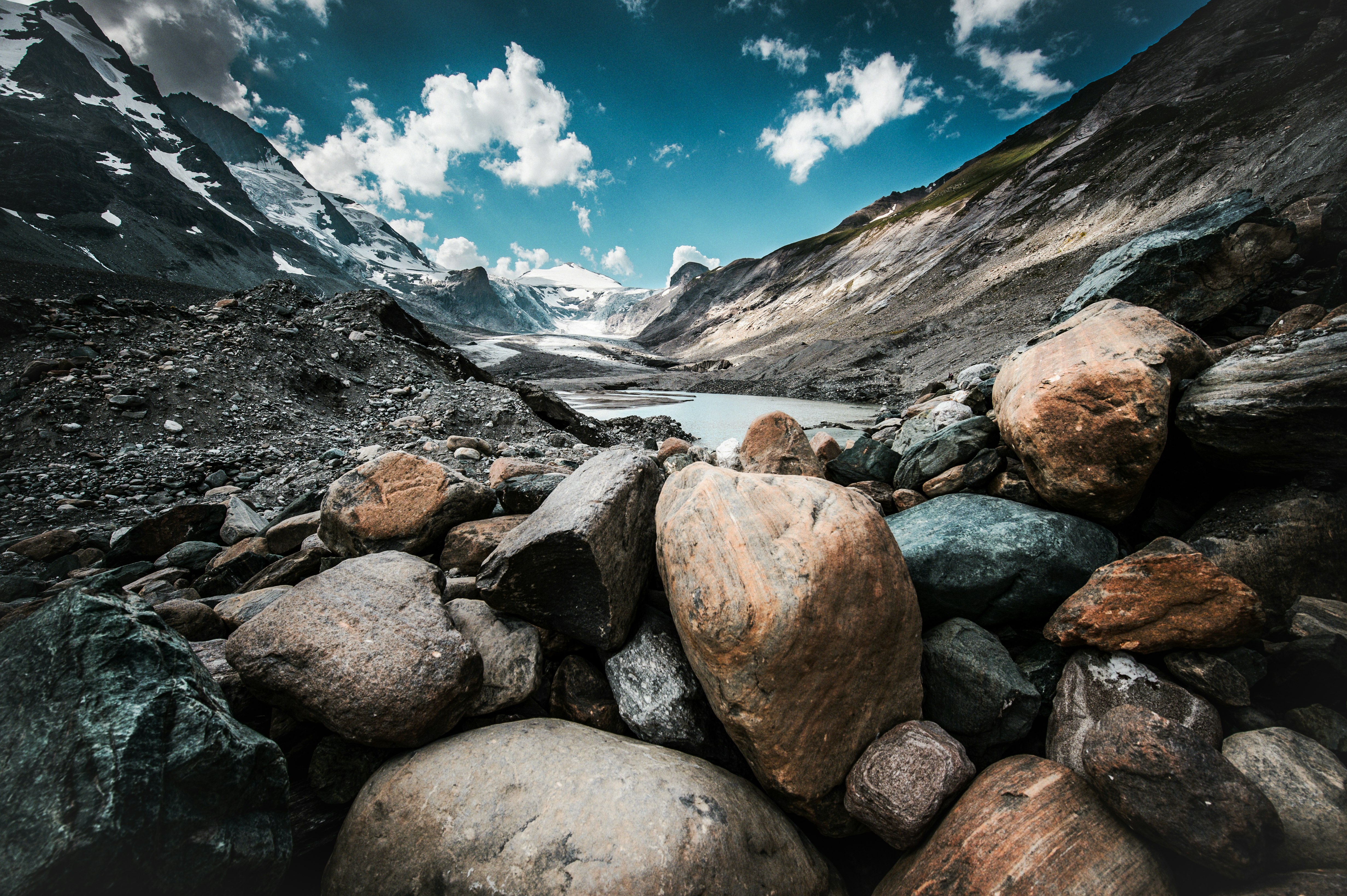 stone at the mountain near body of water