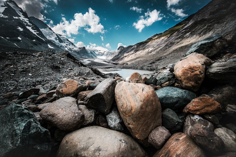 stone at the mountain near body of water