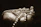 Hand holding a handmade pearl necklace glowing softly under warm light.