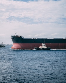black and red ship beside black and white smaller ship