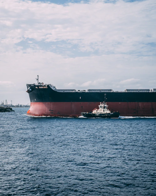 black and red ship beside black and white smaller ship