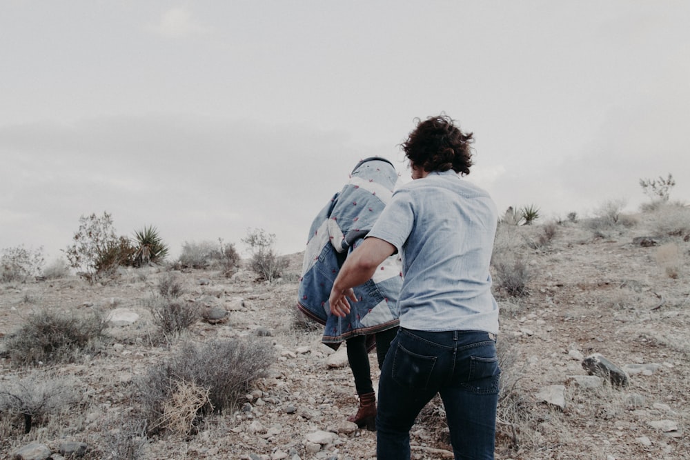 two people running on top of mountain