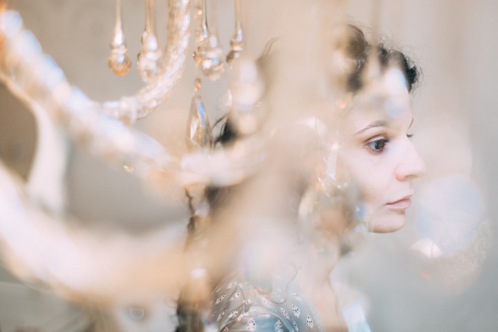 woman behind chandelier