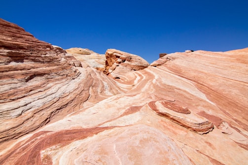 low-angle photography of brown mountains under blue sky during daytime