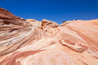 low-angle photography of brown mountains under blue sky during daytime