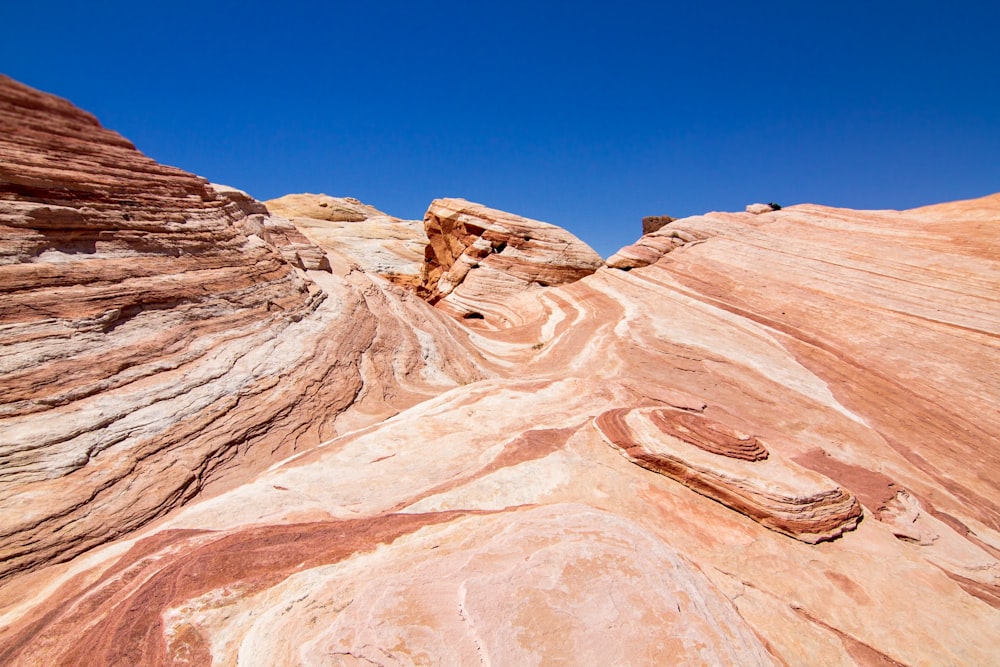 low-angle photography of brown mountains under blue sky during daytime