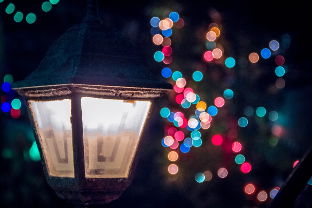 close up photo of lighted lamp post with bokeh light background