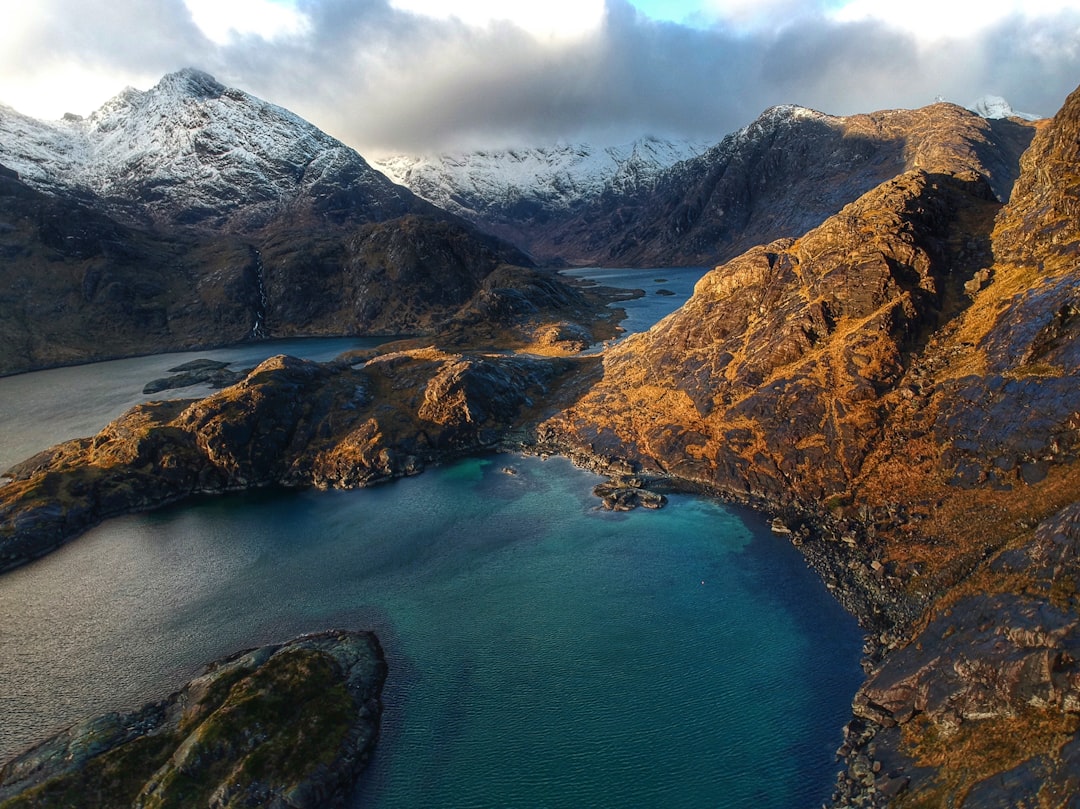 lake and snowy mountain photo, A hidden sea Loch in the black Cuillin mountains