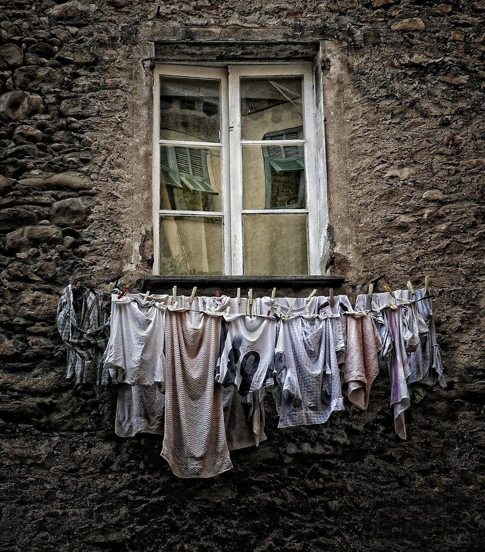 assorted clothes hanged under the window