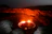 Close-up of a detailed 3D model of a volcanic crater glowing with lava.