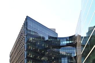 A modern architectural building with large glass windows and a sleek design.