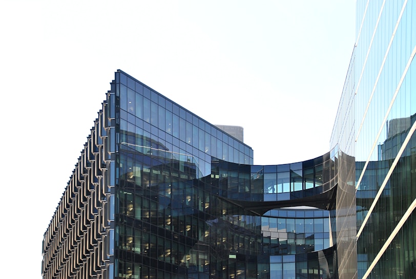 A modern architectural building with large glass windows and a sleek design.