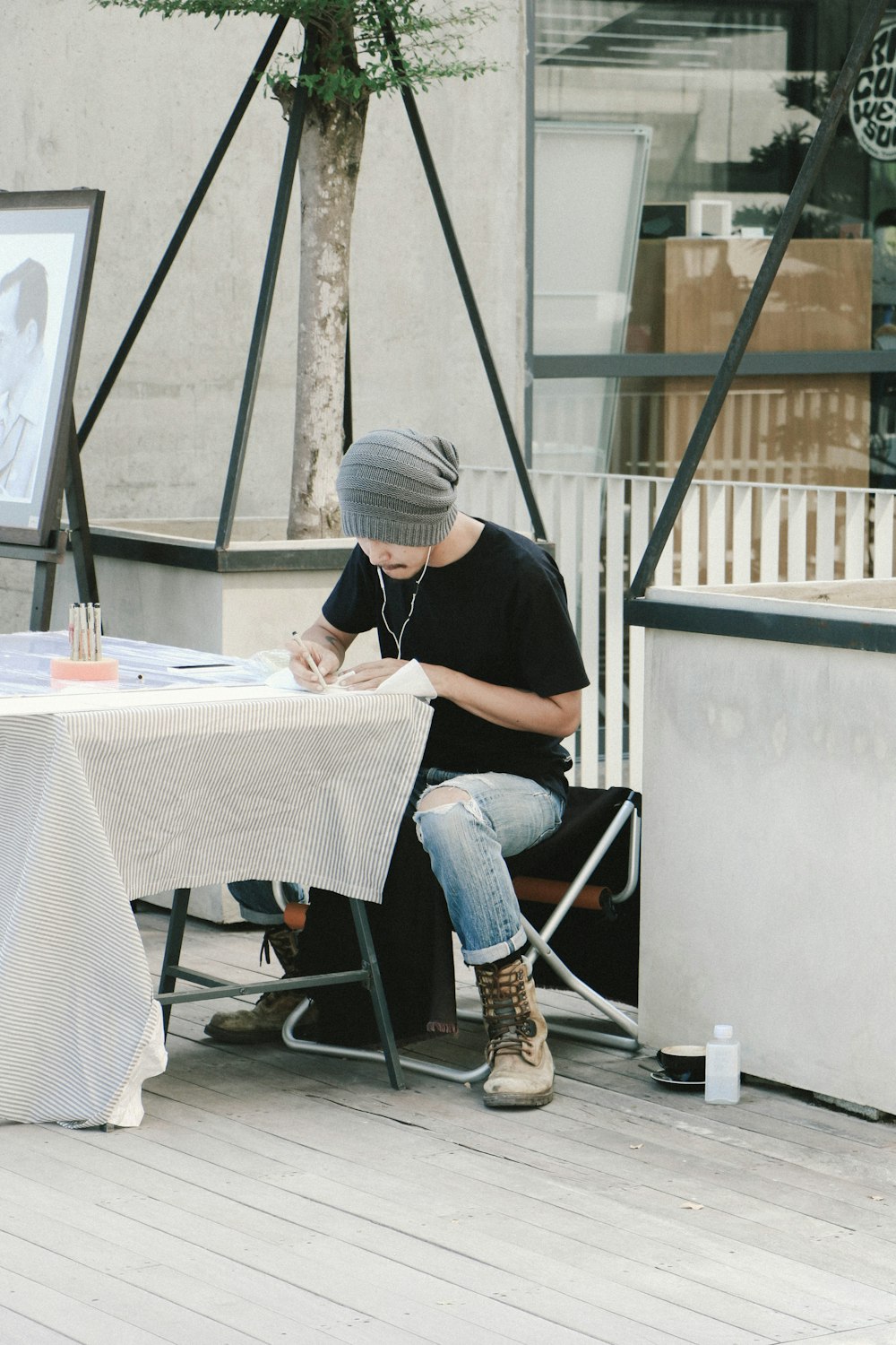 man writing on white printer paper