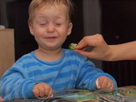 Children learning about nutrition with joyful expressions during a church workshop.