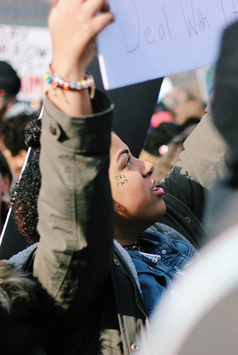 woman raising white placard