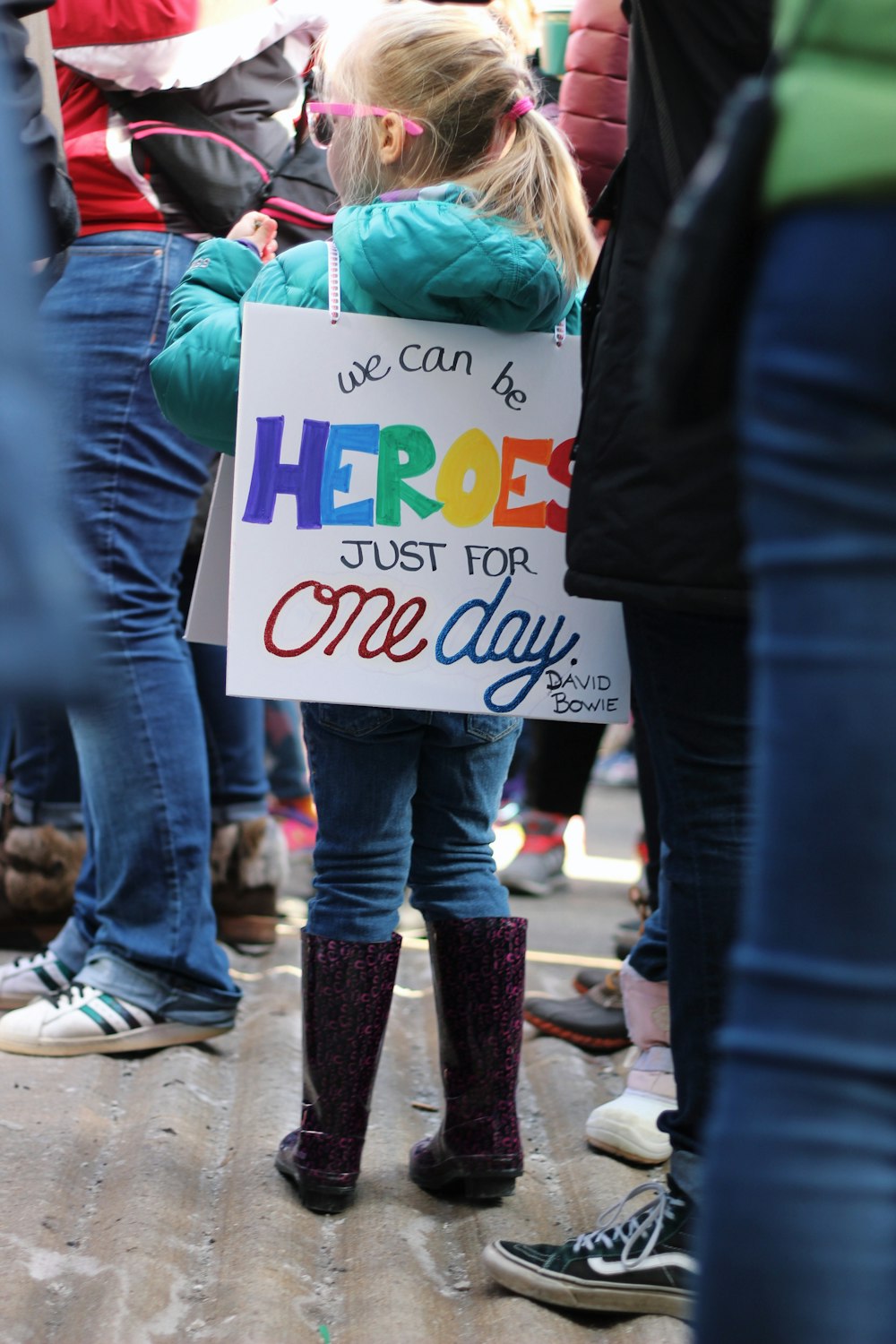 girl carrying white signage board