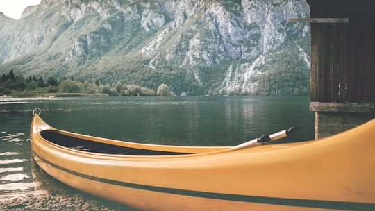 photo of orange kayak on body of water in Triglav National Park Slovenia