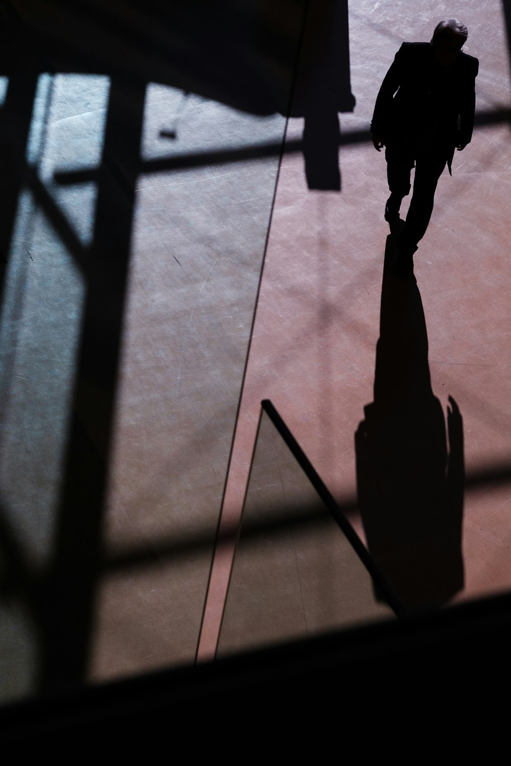 silhouette of person walking inside building