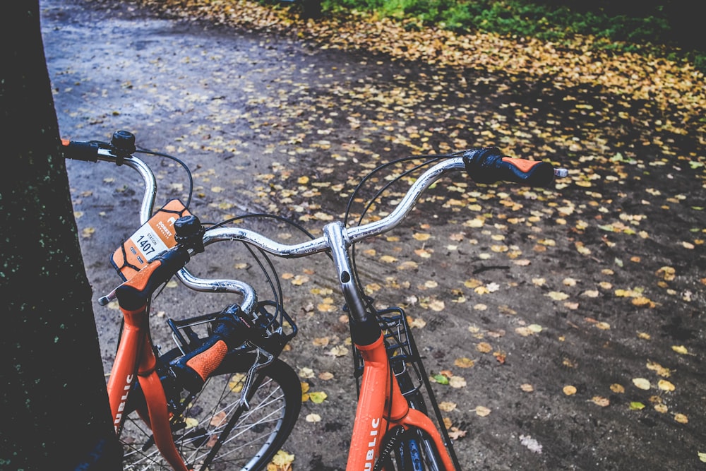 two orange bicycles