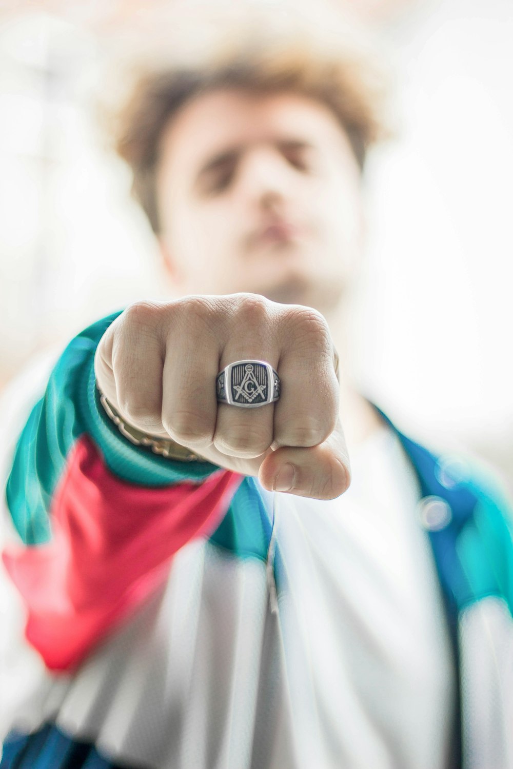 man showing his silver-colored ring