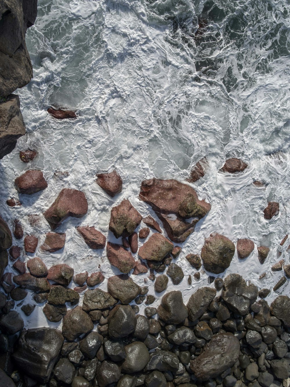 aerial view of rocks on body of water