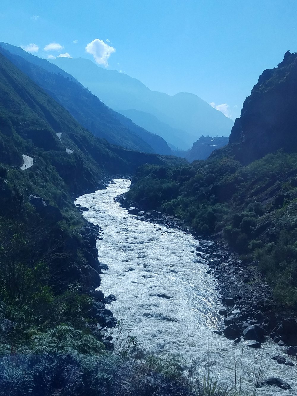 river flowing between green field