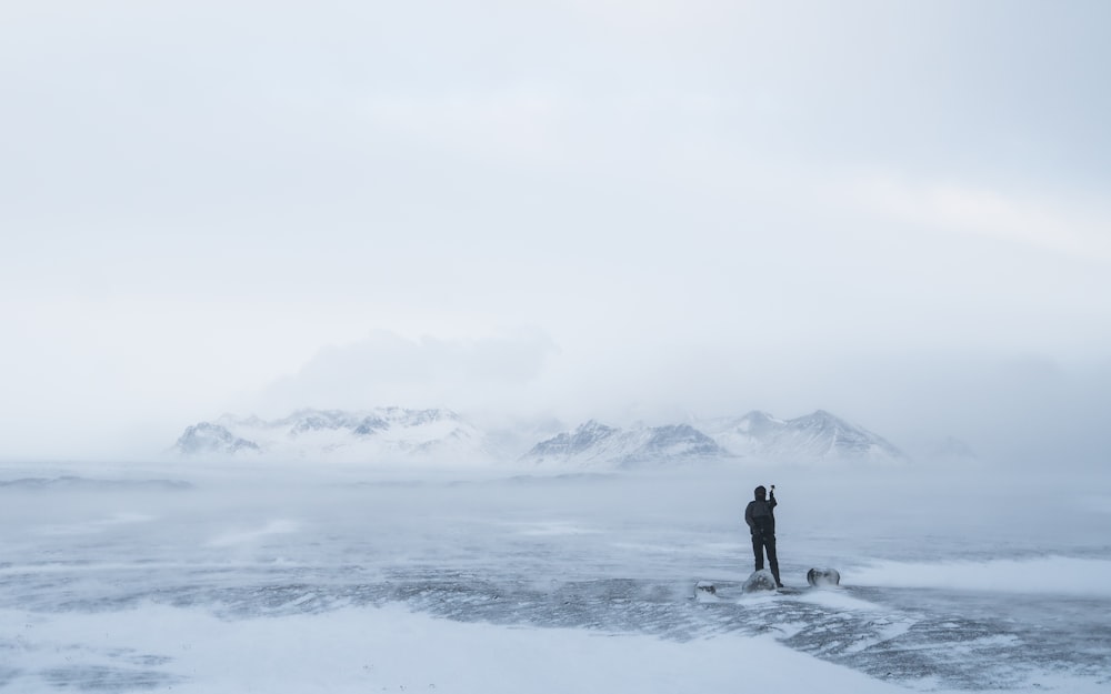 photo of person walking on snow