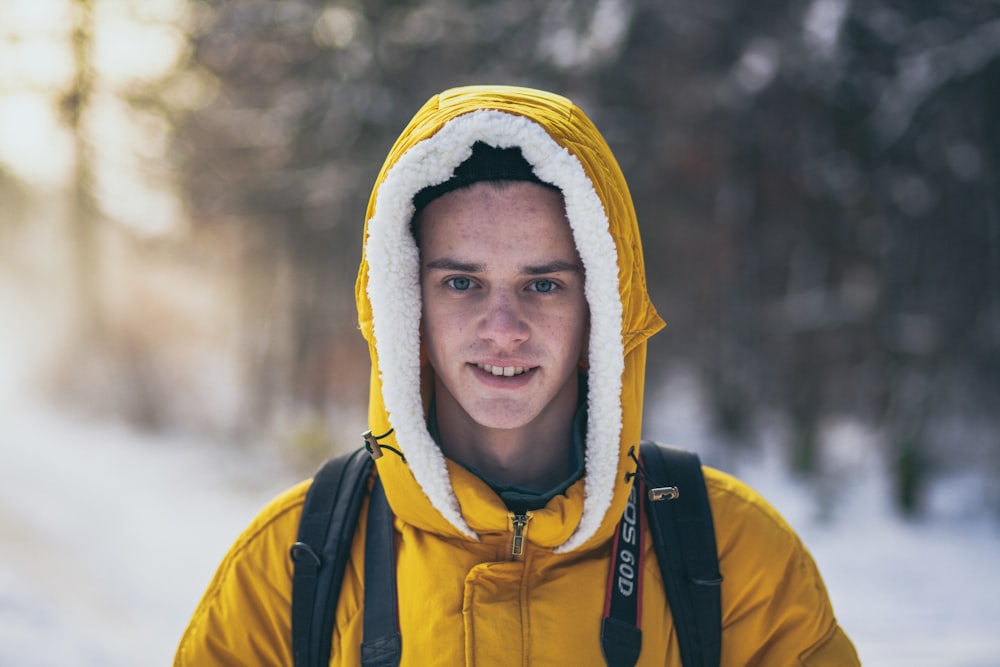 man wearing yellow hooded jacket