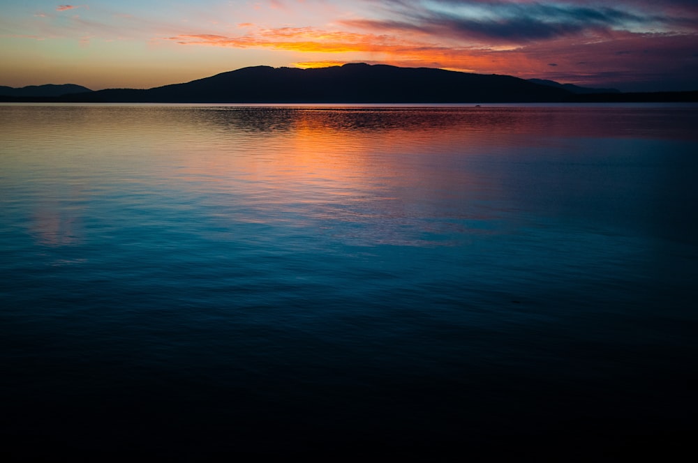 calm body of water during golden hour