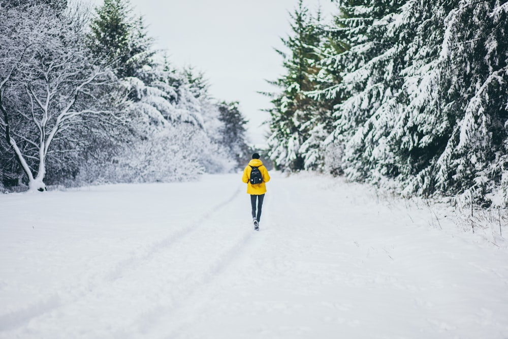 person walking on snow-covered street