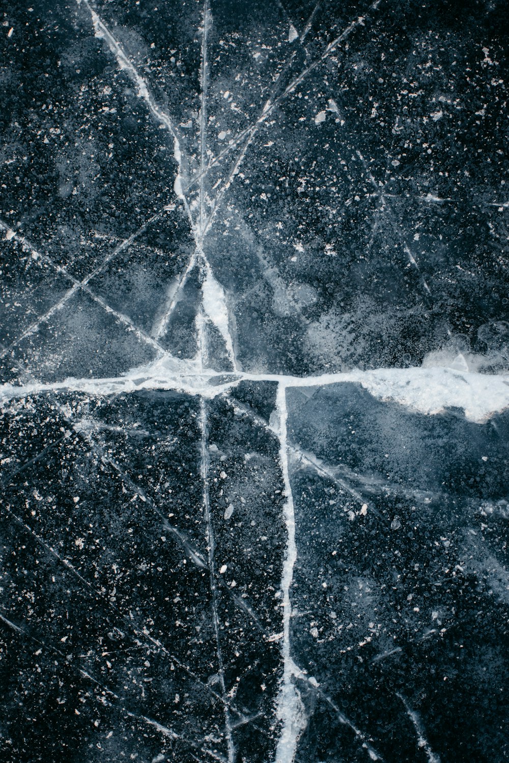 a black and white photo of a cross made of ice