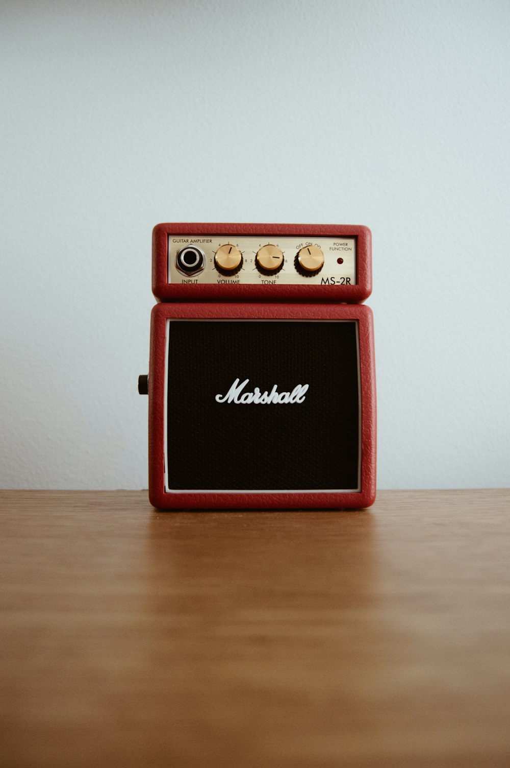 photo of brown Marshal guitar amplifier on brown board