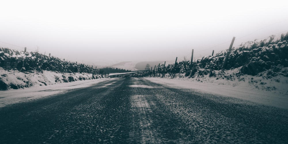 gray concrete road surrounded by snow