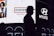 A silhouette of a person wearing a hat stands in front of a brightly lit billboard featuring advertisements for Hunter and Hyundai. The billboard also displays several portrait images of people.