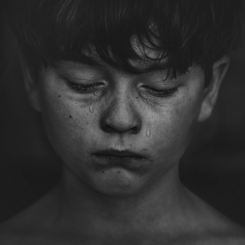 a boy crying tears for his loss