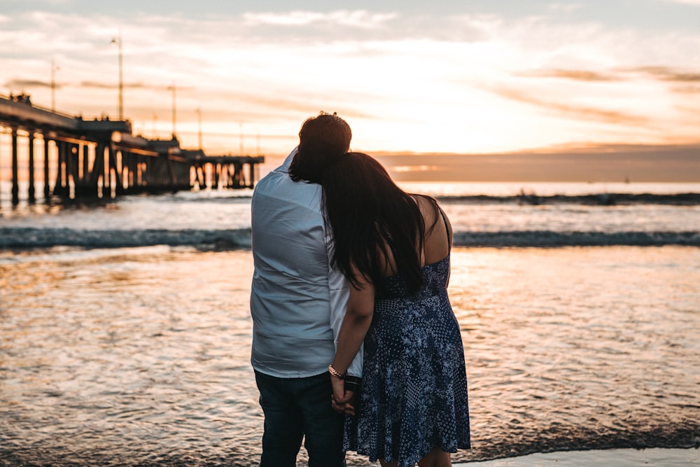 man in dress shirt beside woman in dress