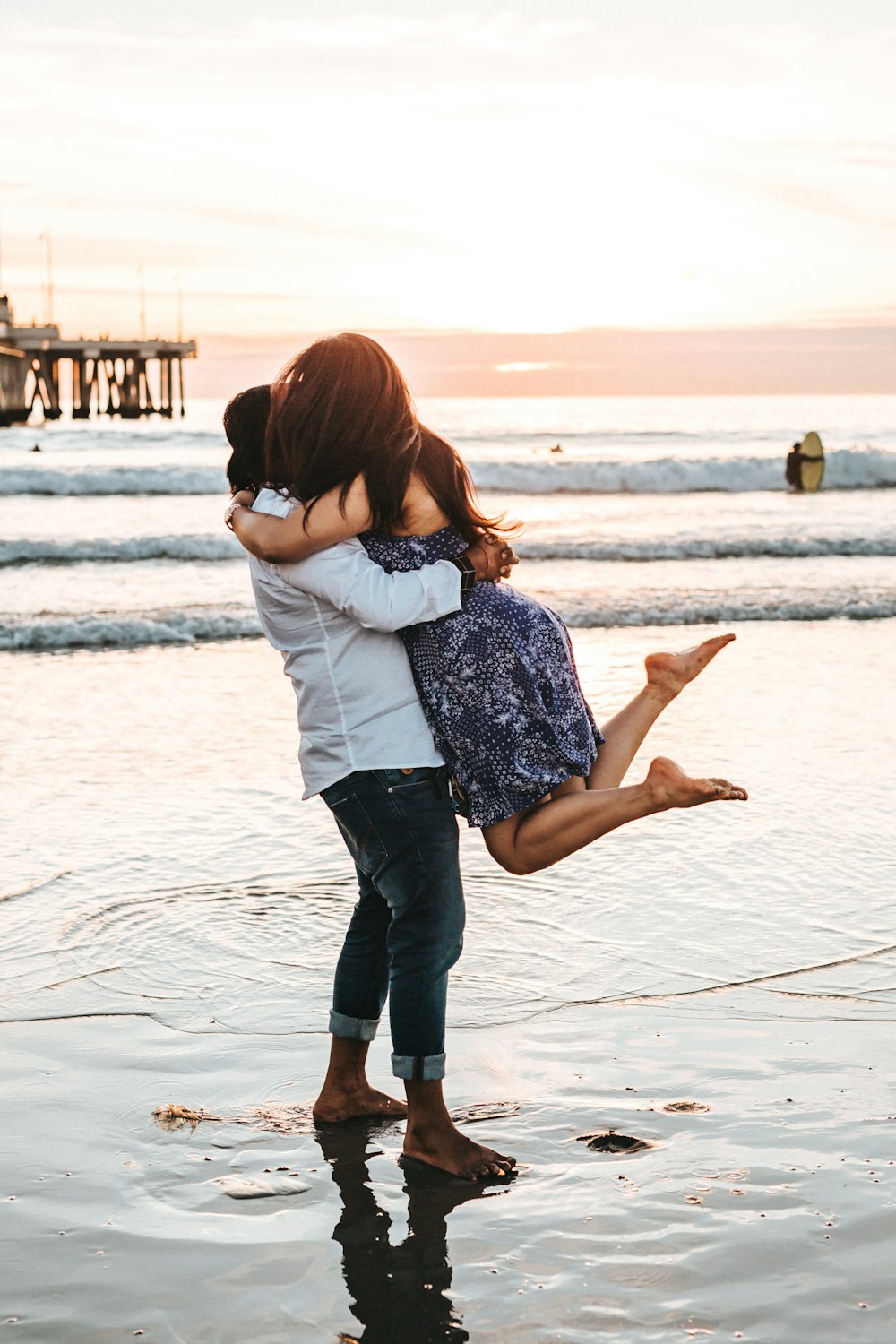 man hugging woman on seashore