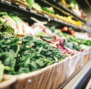 row of vegetables placed on multilayered display fridge