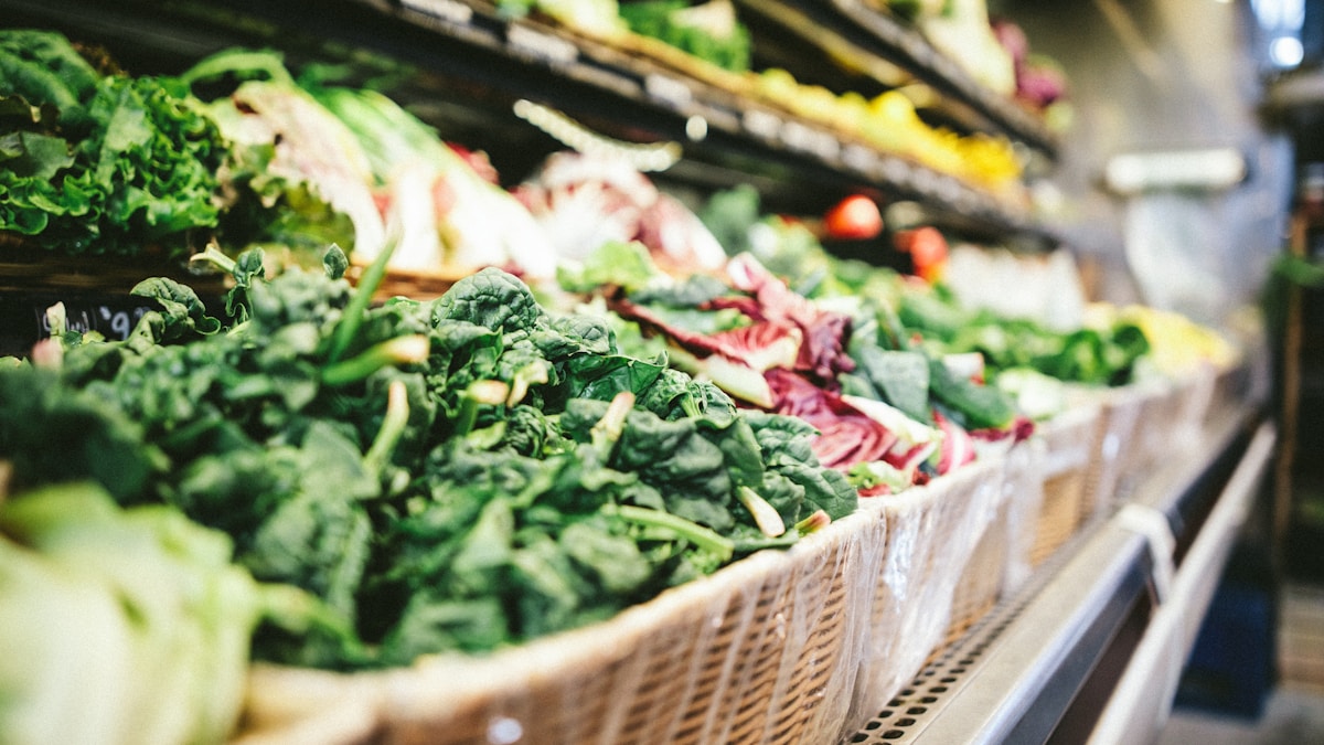 row of vegetables placed on multilayered display fridge